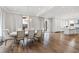 Spacious dining room featuring hardwood floors, large windows with decorative curtains, and elegant chandelier at 14425 Nc-96 N Hwy, Zebulon, NC 27597