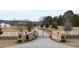 Brick pillars and wrought iron gates open to a long driveway leading to a beautiful home at 14425 Nc-96 N Hwy, Zebulon, NC 27597