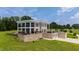 Two-story home with balconies, brick facade, and attached garages nestled in a green landscape at 14425 Nc-96 N Hwy, Zebulon, NC 27597