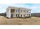 Brick home with columns and a balcony, showcasing a two-story design at 14425 Nc-96 N Hwy, Zebulon, NC 27597