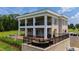 A luxurious outdoor space with seating and a barbecue grill, complemented by a well-kept lawn at 14425 Nc-96 N Hwy, Zebulon, NC 27597