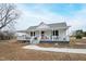 Charming white farmhouse with a wraparound porch at 14425 Nc-96 N Hwy, Zebulon, NC 27597