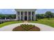 Elegant home featuring prominent columns, manicured landscaping, and a circular driveway at 14425 Nc-96 N Hwy, Zebulon, NC 27597