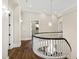 Elegant hallway with hardwood floors and a curved staircase at 14425 Nc-96 N Hwy, Zebulon, NC 27597