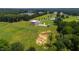 A high angle view of the home shows the patio and luxury home nestled on a private estate with manicured landscaping at 14425 Nc-96 N Hwy, Zebulon, NC 27597