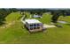 Luxury modern home exterior with multiple levels of balconies and patios overlooking sprawling manicured lawn at 14425 Nc-96 N Hwy, Zebulon, NC 27597