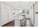 White kitchen with blue range, marble countertops and hardwood floors at 14425 Nc-96 N Hwy, Zebulon, NC 27597