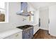 Blue range and white cabinetry in a gourmet kitchen with marble countertops at 14425 Nc-96 N Hwy, Zebulon, NC 27597