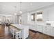 White kitchen with marble island, stainless steel appliances, and hardwood floors at 14425 Nc-96 N Hwy, Zebulon, NC 27597