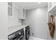 Convenient laundry room with washer, dryer, and overhead shelving at 14425 Nc-96 N Hwy, Zebulon, NC 27597