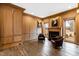 Elegant living room featuring rich wood paneling, fireplace, and leather armchairs at 14425 Nc-96 N Hwy, Zebulon, NC 27597
