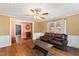 Inviting living room boasts hardwood floors, bright windows, and a comfortable leather couch at 14425 Nc-96 N Hwy, Zebulon, NC 27597