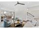 Bright living room with ceiling fan, hardwood floors, and comfortable seating adjacent to the dining room and staircase at 14425 Nc-96 N Hwy, Zebulon, NC 27597