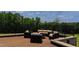 Outdoor patio featuring an outdoor seating set with iron fence and views of the lush green trees at 14425 Nc-96 N Hwy, Zebulon, NC 27597