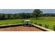 Outdoor patio featuring a small table with chairs and views of the lush green lawns and trees at 14425 Nc-96 N Hwy, Zebulon, NC 27597