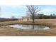 Picturesque pond with a house visible in the background at 14425 Nc-96 N Hwy, Zebulon, NC 27597