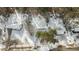 Aerial view of a snow-covered neighborhood with houses and trees at 145 Beaver Ridge Dr, Youngsville, NC 27596