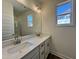 Bathroom featuring double sink vanity, a large mirror, and modern fixtures at 150 W Saltgrass Ln, Smithfield, NC 27577