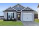 Gray exterior of charming one-story house with two-car garage at 150 W Saltgrass Ln, Smithfield, NC 27577