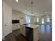 Open-concept kitchen with stainless steel appliances, central island and easy access to living area at 150 W Saltgrass Ln, Smithfield, NC 27577