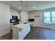 Bright kitchen with a large island, modern pendant lighting, sleek appliances, and dark backsplash at 150 W Saltgrass Ln, Smithfield, NC 27577