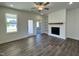 Bright living room with vinyl flooring, a modern fireplace, and access to the backyard at 150 W Saltgrass Ln, Smithfield, NC 27577