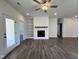 Spacious living room featuring a modern fireplace, built-in shelving, and luxury vinyl flooring at 150 W Saltgrass Ln, Smithfield, NC 27577