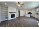 Open-concept living room and kitchen featuring modern fireplace and island with counter seating at 150 W Saltgrass Ln, Smithfield, NC 27577