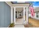 Front porch with rocking chairs and American flag at 1509 Hornbeam Rd, Fuquay Varina, NC 27526