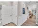 Bright hallway with white doors and wood floors at 1509 Hornbeam Rd, Fuquay Varina, NC 27526