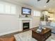 Spacious living room with a fireplace, built-in shelving, and hardwood floors at 1572 Lone Prairie Dr, Wendell, NC 27591