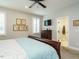 Main bedroom with king-size bed, en-suite bathroom access, and a TV at 1572 Lone Prairie Dr, Wendell, NC 27591