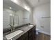 Bathroom featuring double vanity, granite countertops, large mirror, and walk-in shower at 160 W Saltgrass Ln, Smithfield, NC 27577