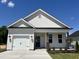 Charming new construction home with a white exterior, front-facing garage, and manicured lawn at 160 W Saltgrass Ln, Smithfield, NC 27577