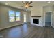 Bright living room showcasing modern fireplace, hardwood floors, and backyard access at 160 W Saltgrass Ln, Smithfield, NC 27577