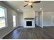 Cozy living room featuring a modern fireplace, neutral walls, and hardwood floors at 160 W Saltgrass Ln, Smithfield, NC 27577