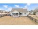 House exterior showcasing screened porch and backyard at 1704 Little Drake Ave, Willow Springs, NC 27592