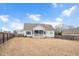 Rear view of house showcasing screened porch and yard at 1704 Little Drake Ave, Willow Springs, NC 27592