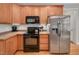 Modern kitchen featuring stainless steel appliances and wood cabinets at 1704 Little Drake Ave, Willow Springs, NC 27592