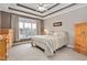 Main bedroom with tray ceilings and large window overlooking backyard at 1704 Little Drake Ave, Willow Springs, NC 27592