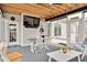 Relaxing screened porch with seating area, TV, and access to backyard at 1704 Little Drake Ave, Willow Springs, NC 27592