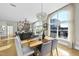 Sunlit dining area with hardwood floors and a modern chandelier at 200 S Dawson St # 406, Raleigh, NC 27601