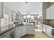 Modern kitchen with white cabinets, granite countertops and stainless steel appliances at 200 S Dawson St # 406, Raleigh, NC 27601