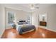 Main bedroom with hardwood floors, ceiling fan, and ensuite bathroom at 204 Serenity Hill Cir, Chapel Hill, NC 27516