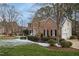 Side view of two-story brick home with a partially snow-covered yard at 206 Joseph Pond Ln, Cary, NC 27519