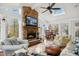 Sunroom with stone fireplace, seating area, and view at 206 Joseph Pond Ln, Cary, NC 27519