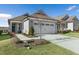 Gray craftsman style home with two car garage, landscaping, and walkway at 219 Brookhollow Way, Clayton, NC 27520