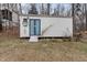 White storage shed with blue doors and yard art at 2208 Lawrence Dr, Raleigh, NC 27603