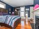 Bright bedroom featuring hardwood floors and a fireplace at 2517 Academy St, Sanford, NC 27332