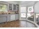 Kitchen features gray cabinets, stained glass window, and tile floor at 2517 Academy St, Sanford, NC 27332